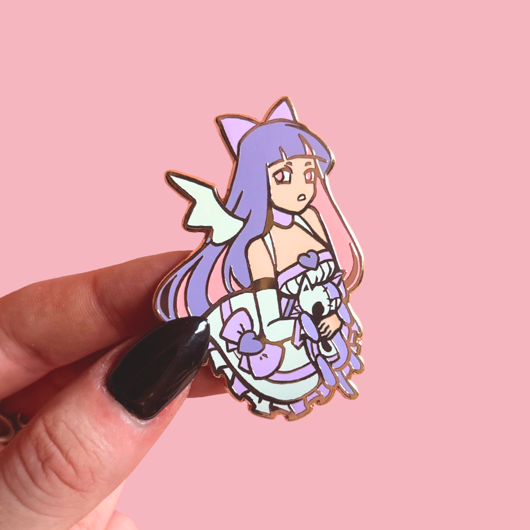 Enamel pin of an anime-style character with purple hair and a cat-like creature on a pink background