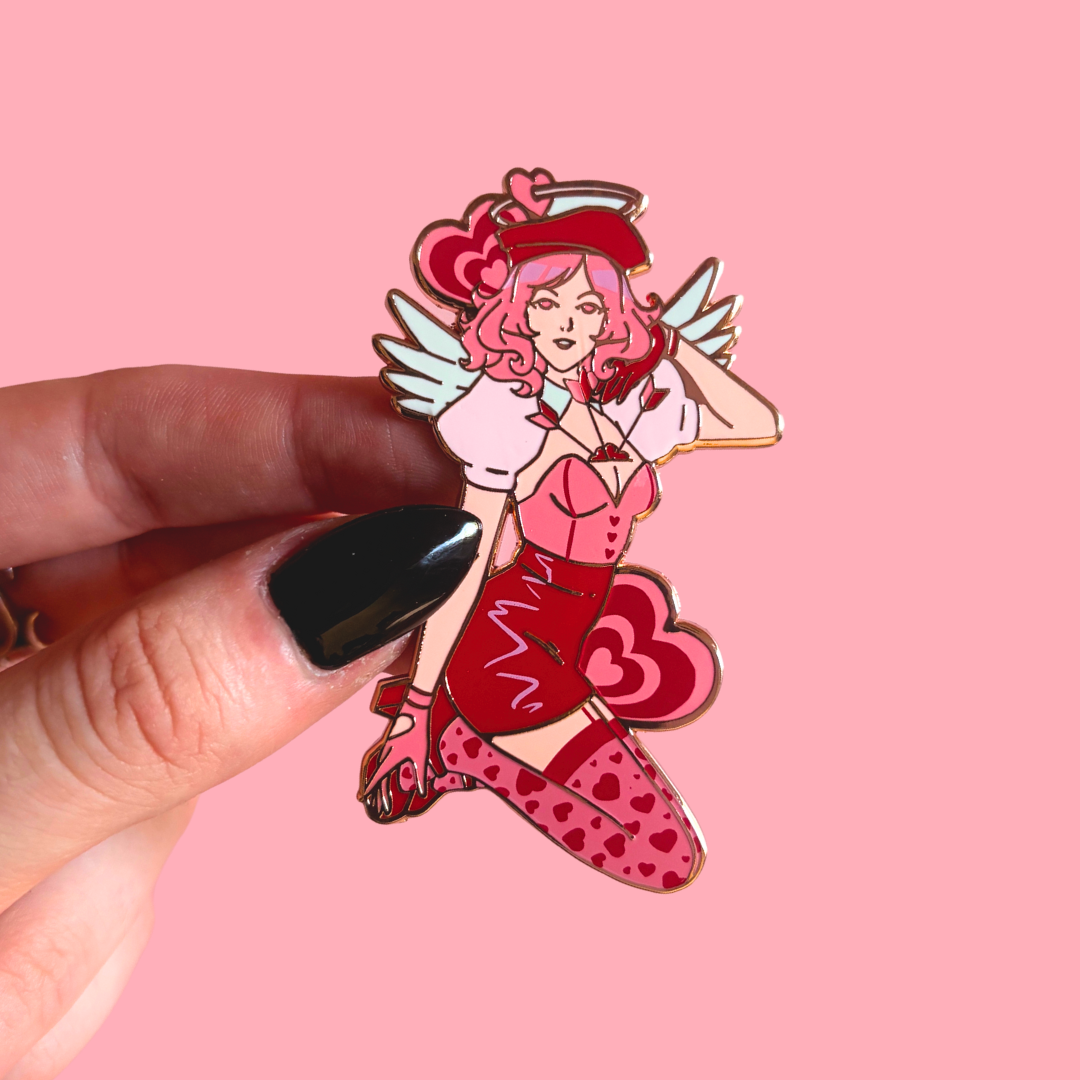 Pin with pink angel character on a pink background