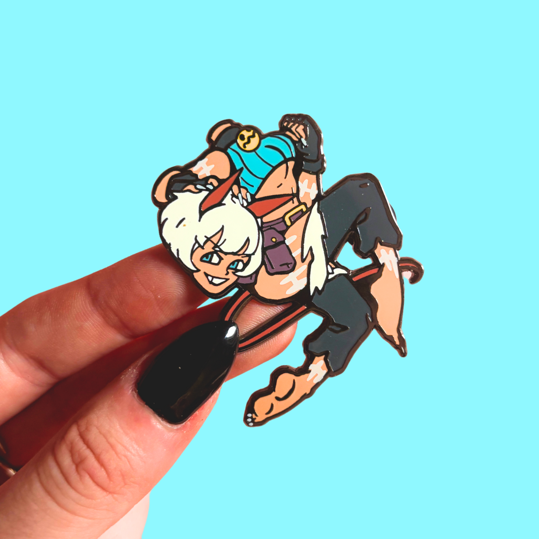Animated character pin held by a hand against a blue background