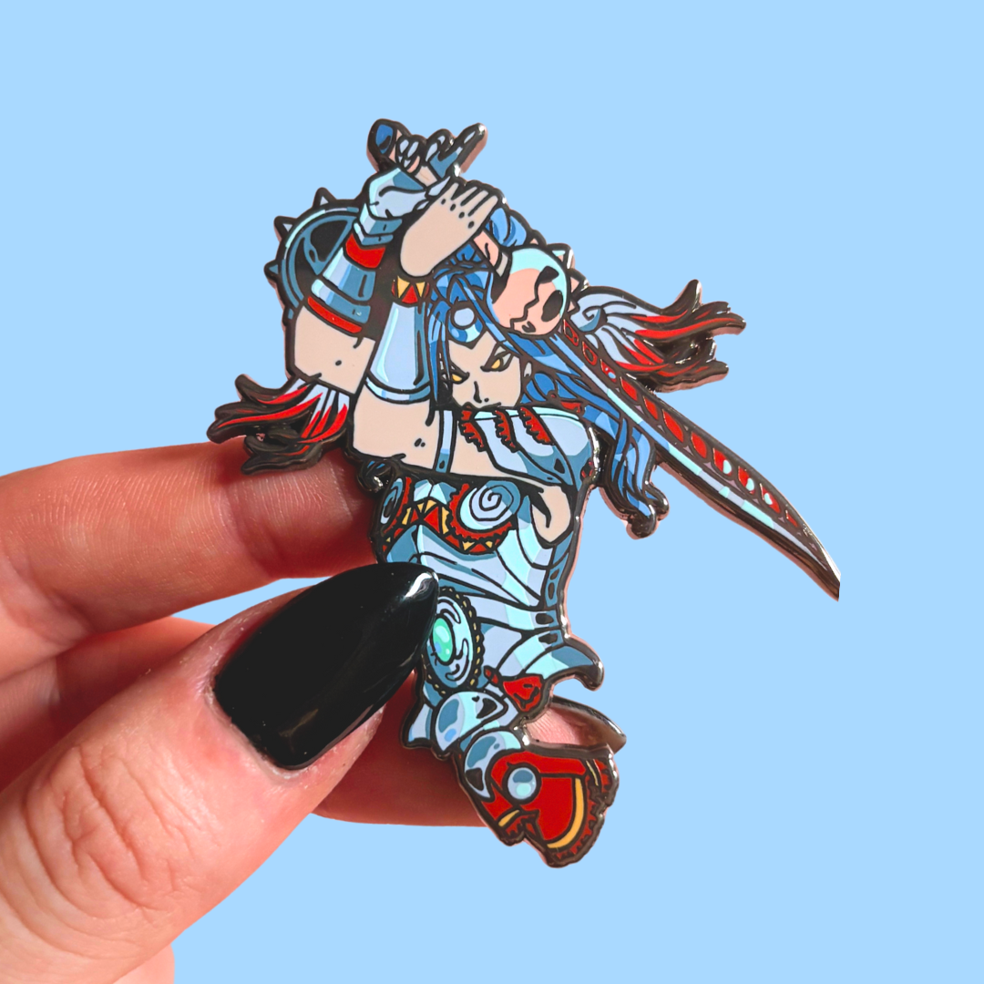 Colorful anime-style character pin held by a hand against a blue background