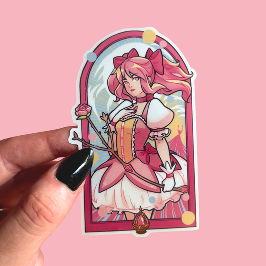 Sticker of an animated character with pink hair and a pink frame held by a hand on a pink background