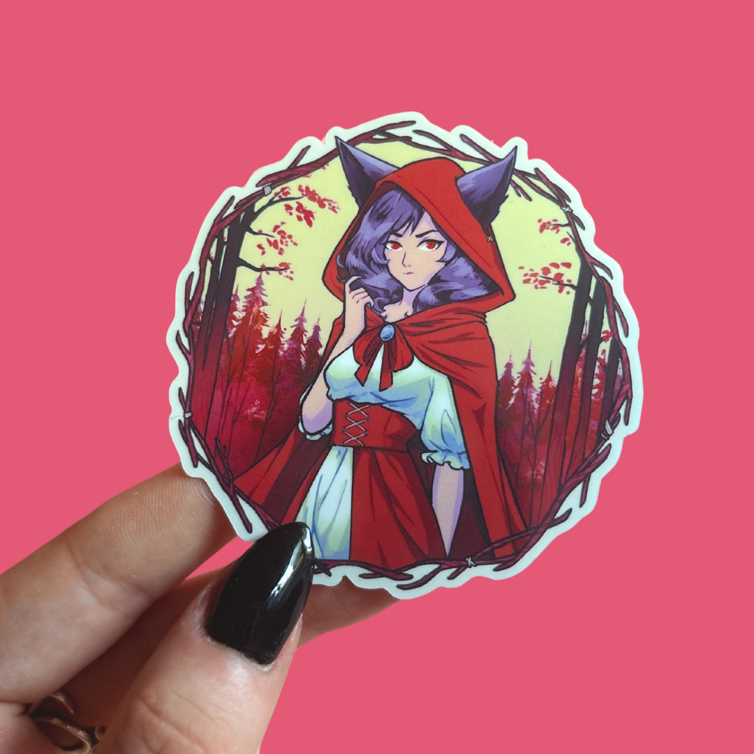 Sticker of a character in a red hood and purple hair held against a pink background