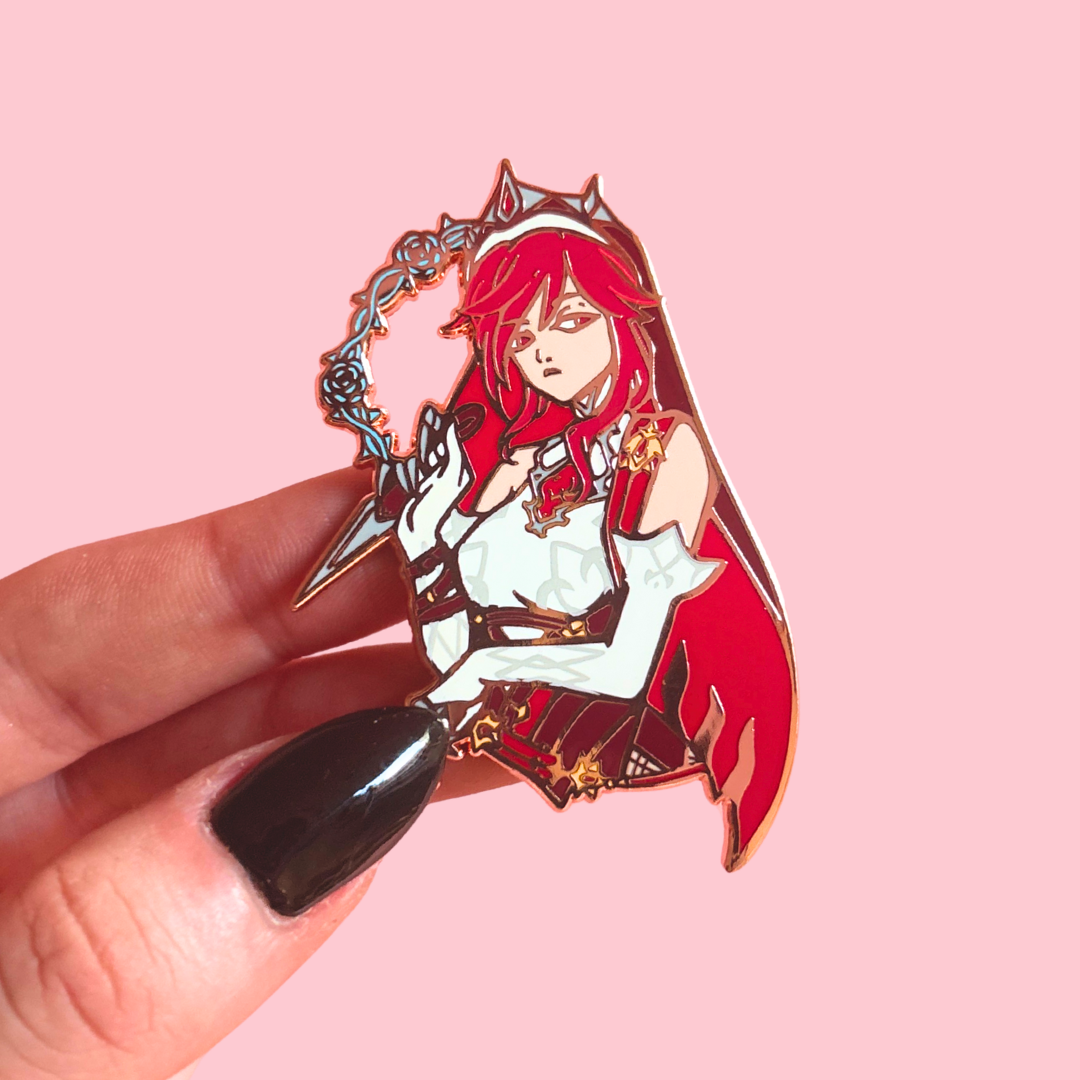Enamel pin with an anime-style character held by a hand on a pink background