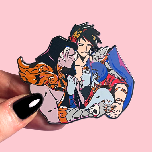 Hades enamel pin with Zagreus, Meg and Thanatos held by a hand on a pink background