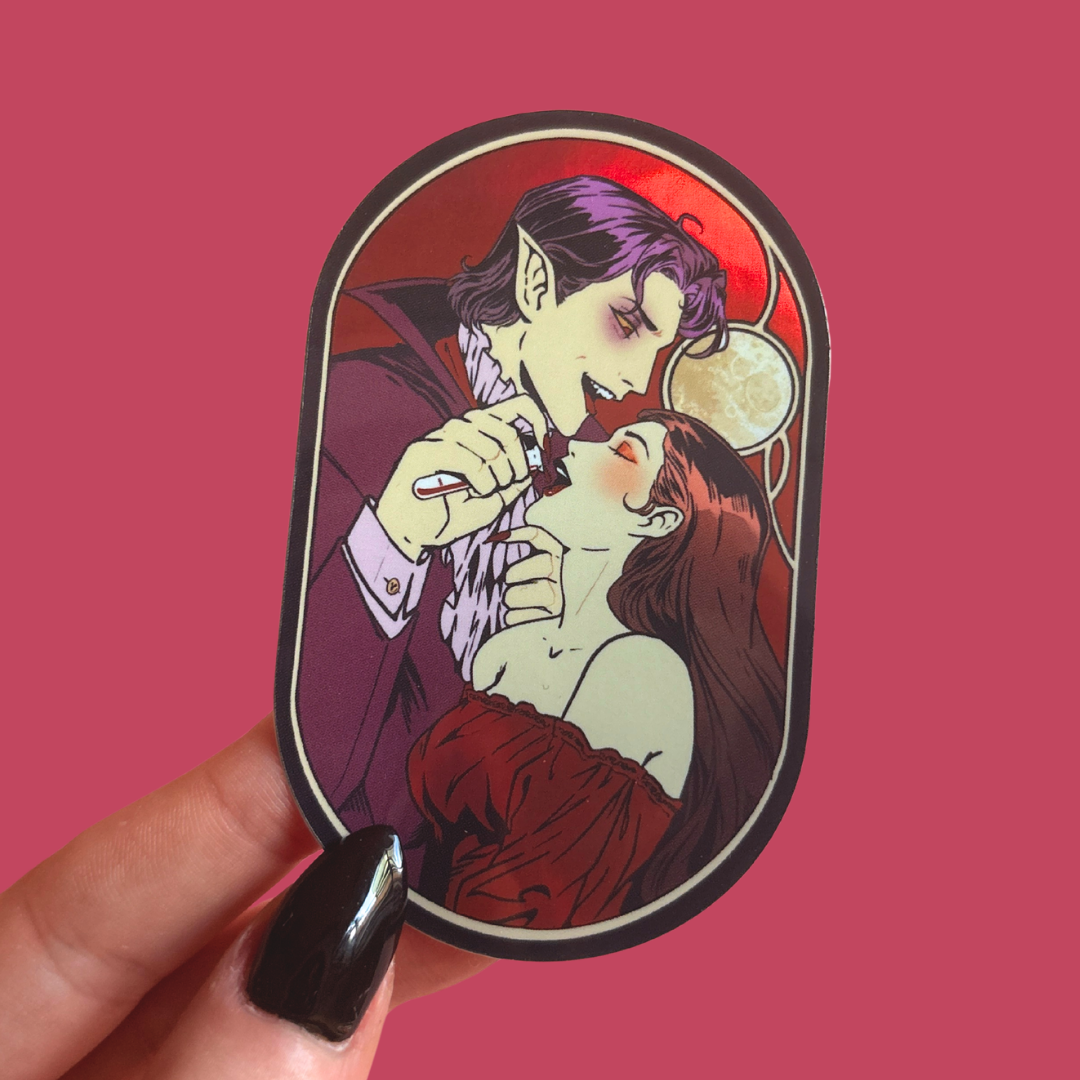 Sticker of a vampire feeding on a woman's neck, held against a pink background