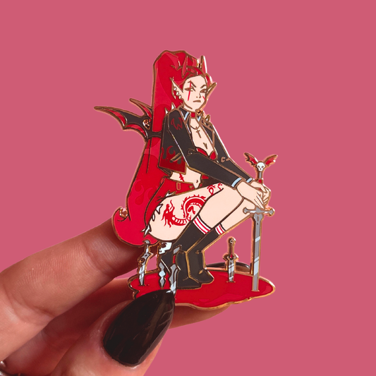 Pin with an red demon like character holding a sword against a pink background